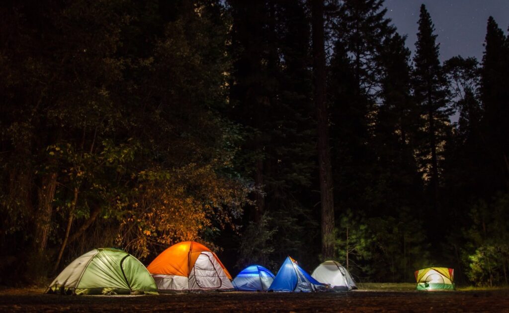 six camping tents in forest